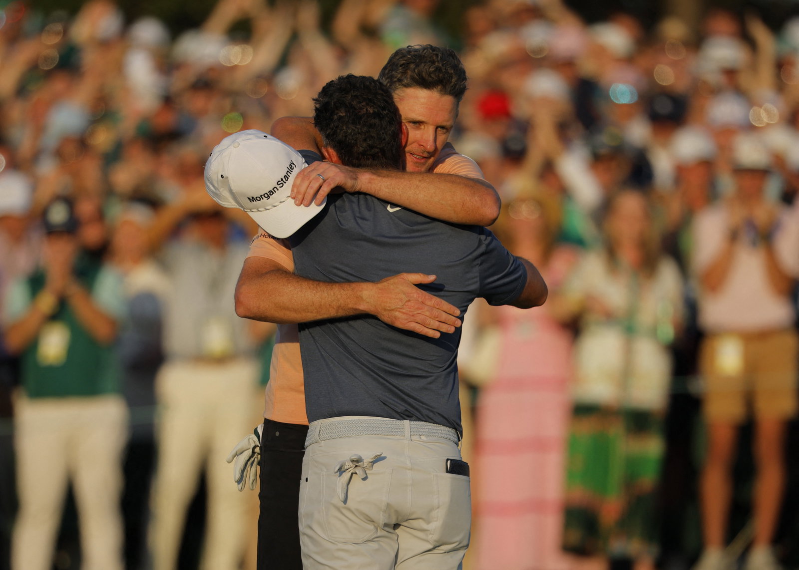 Rose hugs McIlroy on the 18th green
